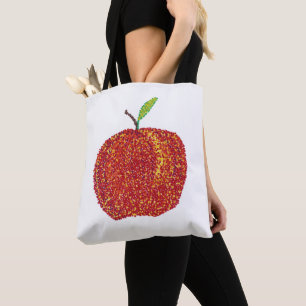 Pomme rouge mûre entière dans les Sacs fourre-tout