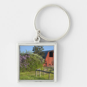 Porte-clés Buissons de lilas en fleurs et pies dans les arbre