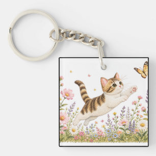 Porte-clés Chat brodé poursuivant un papillon dans une prairi