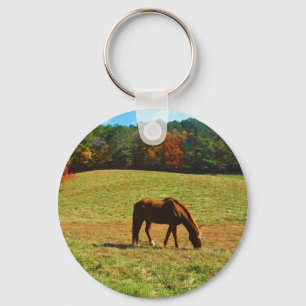 Porte-clés Cheval Brown rouge dans les arbres d'automne