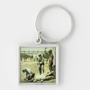 Porte-clés Cowboys américains stigmatisant un veau, c.1900
