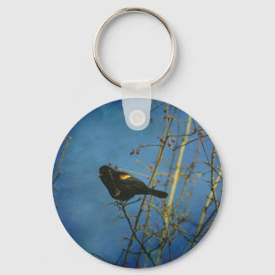 Porte-clés Oiseau noir à ailes rouges chantant