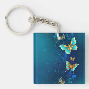 Porte-clés Papillons d'or sur un Arrière - plan bleu