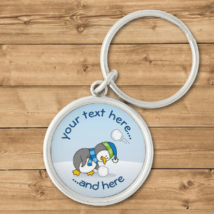 Porte-clés Petit manchot obtenant une boule de neige