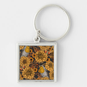 Porte-clés Robins dans le jardin d'automne sur noir
