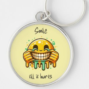 Porte-clés sourire jusqu'à ce que ça fasse mal