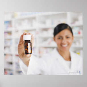 Poster Pharmacist in drug store holding out pill bottle