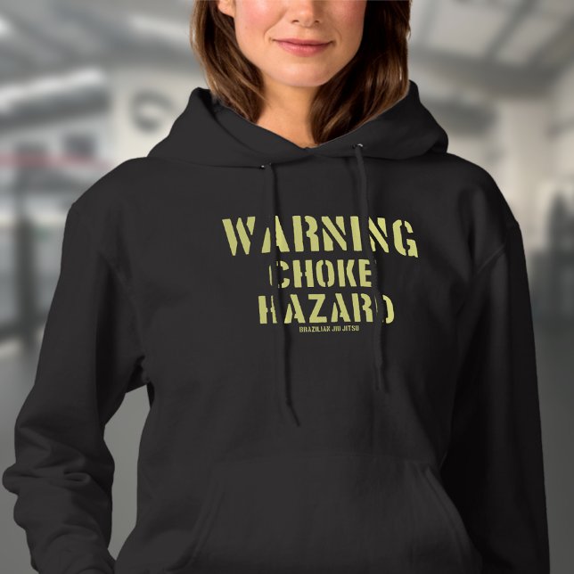 Pull À Capuche BJJ Warning Choke Hazard brésilien Jiu Jitsu (Choke hazard woman's black hoodie worn by a female model in a gym.)