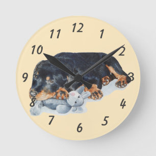 puppy cuddling teddy bear rottweiler dog runde wanduhr
