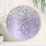 Purple Brushed Metal Silver Glitter Monogram Name Runde Wanduhr<br><div class="desc">Easily personalize this trendy chic round clock design featuring pretty silver sparkling glitter on a purple brushed metallic background.</div>