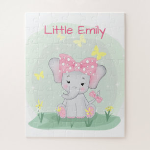Puzzle Beau éléphant avec un arc rose dans une clairière