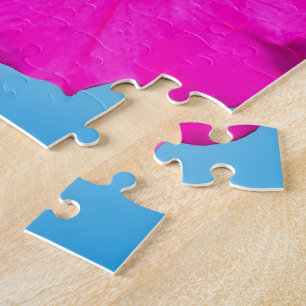 Puzzle fleur de pétunia rose sur fond bleu.