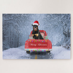 Puzzle Rottweiler assis dans un camion de Noël enneigé