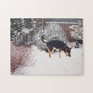 Puzzle Winter snow scene with cute black and tan dog