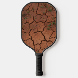 Raquette De Pickleball terrain sec et fissuré