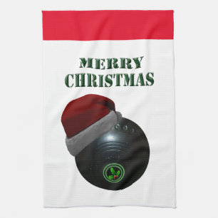Rasenschale mit einer Weihnachtsmannmütze, Geschirrtuch