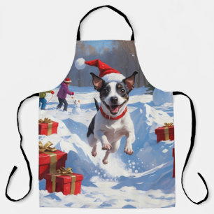 Rat Terrier läuft im Schnee mit Weihnachtshut Schürze