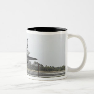 Raumfähre-Entdeckung nähert sich Landung Zweifarbige Tasse