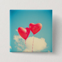 Red Heart Balloons Against Cloudy Sky