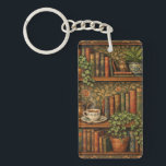 Retro book lover art schlüsselanhänger<br><div class="desc">A cozy retro-inspired design featuring a charming bookshelf filled with vintage books,  delicate botanical accents,   and a comforting cup of tea or coffee.</div>