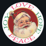 Retro Classic Santa Christmas Hope Peace Runder Aufkleber<br><div class="desc">Im Mittelpunkt dieses Holiday-Aufklebers steht ein klassisches Bild des Weihnachtsmanns mit seiner roten Fellkappe, rosigen Karos, blinkenden Augen und weißem Bart. Das Bild des Weihnachtsmannes wird auf einem dunkelroten, goldfarbenen Hintergrund gerahmt. Der Text in rot und grün um den weißen Rand herum sagt "Liebe Hoffnung Frieden Freude". Ideal für Weihnachtskarten...</div>