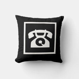 Retro-weißes Telefon auf schwarzem Kissen
