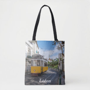Retrogelbe Straßenbahn auf einer Straße in Lissabo Tasche
