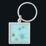 Robin's Egg Blue Atomic Sternexplosion Schlüsselan Schlüsselanhänger<br><div class="desc">Dieses Robin’s Ei Blue Iconic Atomic Sternexplosion Schlüsselanhänger Muster weist ikonische atomare Sternexplosionen auf. Das ist richtig! Die alte Schule, robinfarbener Hintergrund mit goldenen Falten ist der perfekte Hintergrund für die lebendigen, türkisfarbenen, beruhigenden Sellerie und die kitschigen Birnen-grünen Kreise. Die Farbflecken sind sporadisch in verschiedenen Größen platziert, mit überlegenen schwarz-V-förmigen...</div>