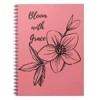 Rosa Blumenblüte mit Grau-Notebook Notizblock