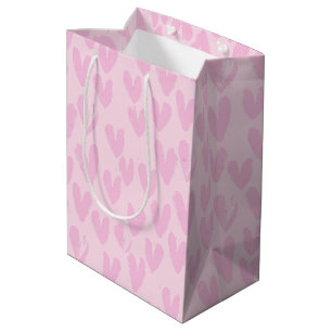 Rosa Herzen auf rosa Mittlere Geschenktüte