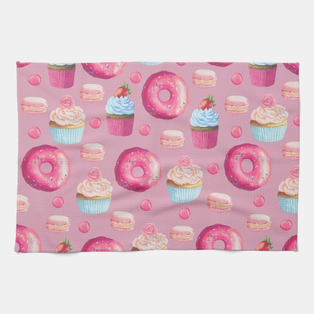 Rosa Schaumgummiringe, kleine Kuchen und Küchentuch (Horizontal)