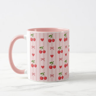 Rosa Tasse mit roten Kirschen und roten Schleifen