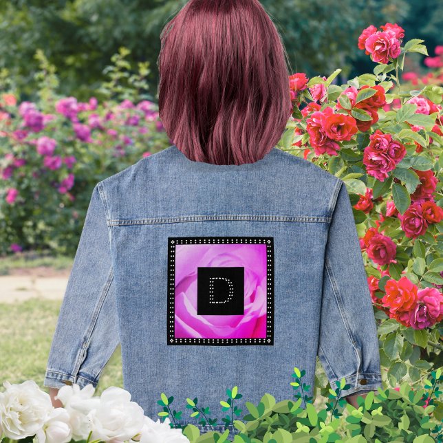 Rose Diamante effet Cool tendance Monogramme (A denim jacket with pink rose image with faux diamante monogram on a black square)