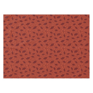 Rot verlässt Muster auf Orange Tischdecke