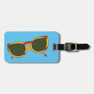 Rote gelbe Sonnenbrille-blauer Gepäckanhänger