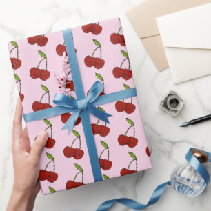 Rote Kawaii-Kirschen in Rosa Geschenkpapier