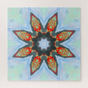 Rote Orange Sternblume auf blauem Puzzle