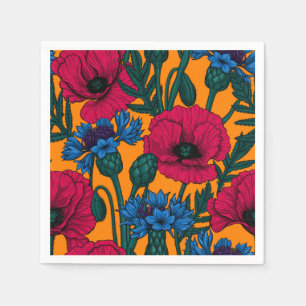 Rote Pfeffer und blaue Kornblumen auf Orange Serviette