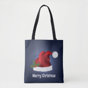 Rote Santa-Mütze mit Weihnachtsholly auf Blau Tasche