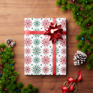 Rote und grüne Weihnachtsschneeflocken auf Weiß Geschenkpapier