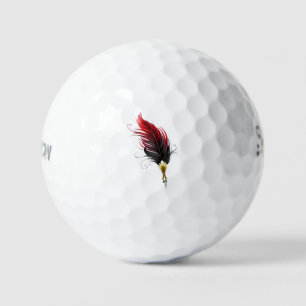 Roter Federhalter mit Goldfeder Golfball