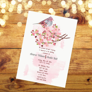 Roter Vogel und rosa Kirschblüten