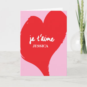 Rotes Herz mit je t’aime-Text auf rosa Hintergrund Karte
