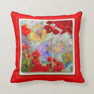 Rotes Kissen mit roten Pelargonien durch Sharles