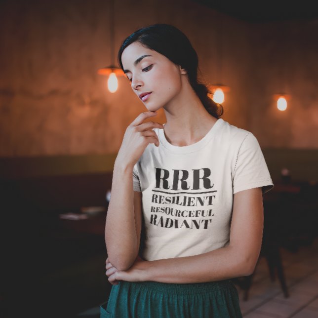 RRR- widerstandsfähig, ressourcenschonend, strahle T-Shirt (Young woman in thoughtful pose wearing a "RRR: Relilient, Resourceful, Radiant" white t-shirt.)