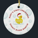 Rubber Duck Baby's First Christmas Bubbles Foto Keramik Ornament<br><div class="desc">Illustration eines Spielzeugs aus gelbem Gummidraht mit einer Weihnachtsmannmütze,  umgeben von Blasen. Personalisieren Sie Ihre persönlichen Daten mit dem Namen und dem Jahr des Babys. Personalisieren Sie das Foto auf der Rückseite.</div>