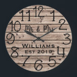 Rustic Personalized Brown Wood Custom Große Wanduhr<br><div class="desc">Beautiful, unique, one-of-a-kind personalized design features a faux-rustic brown wood with black personalization his and her names in a script font overlay design and the last name and year established in a bold script with a printed wood effect background. Personalize this clock by adding your personal information. Makes a great...</div>