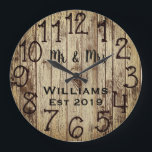 Rustic Personalized Brown Wood Custom Große Wanduhr<br><div class="desc">Beautiful, einzigartig, one-of-a-kind personalized design feature a-rustic brown wood with black personalization his and her names in a script machen overlay design and the last name and year establishd in a bold script with a printed wood background. Personalize this clock by adding your personal information. Makes a great wedding, anniversary,...</div>