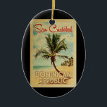 San Cristobal Palm Tree Vintage Travel Keramik Ornament<br><div class="desc">A uniquely retro mid-century modern San Cristobal Dominican Republic art print in vintage travel poster style. It features a curved palm tree on sandy beach with ocean under a blue cloudy sky.</div>