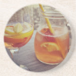 Sangria and Sunshine Getränkeuntersetzer<br><div class="desc">This image shows a refreshing glass and pitcher of citrus sangria, perfect for a warm day. The fresh slices of lemon and orange add bright colour and hint of natural sweetness. One glass sits ready to enjoy while sangria is being poured from a small glass pitcher beside it, perfect for...</div>